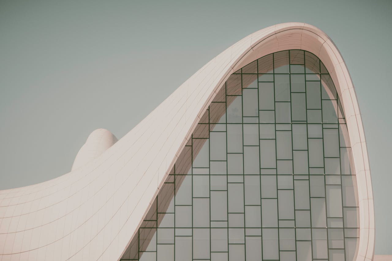 Futuristic curved building with modern glass design, showcasing innovative architectural elements.